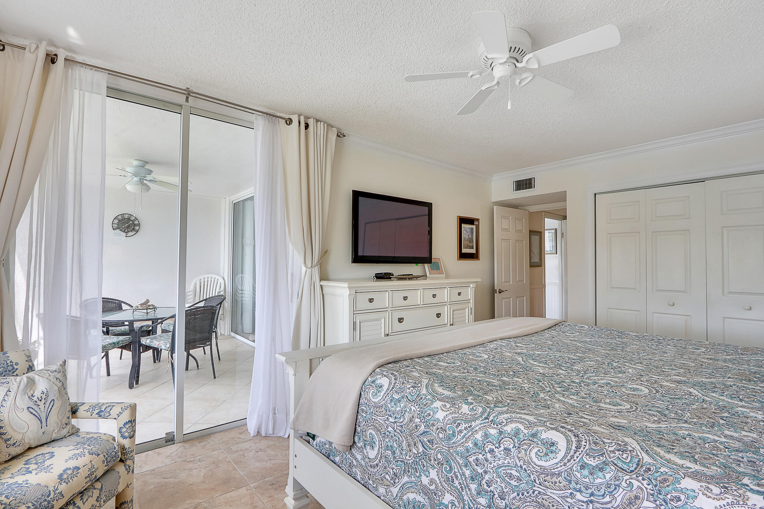 353 Highway 1, Unit A207 Jupiter, FL 33477 - Photo 15 of 28 a spacious bedroom with a bed and a flat screen tv