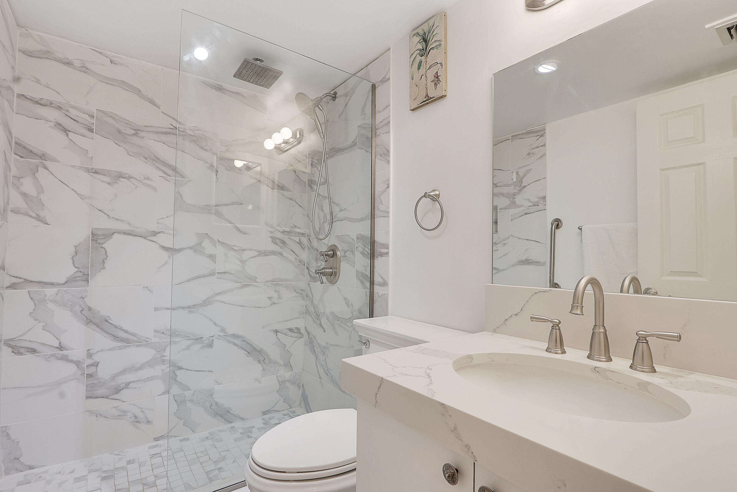 353 Highway 1, Unit A207 Jupiter, FL 33477 - Photo 19 of 28 a bathroom with a sink a toilet and shower