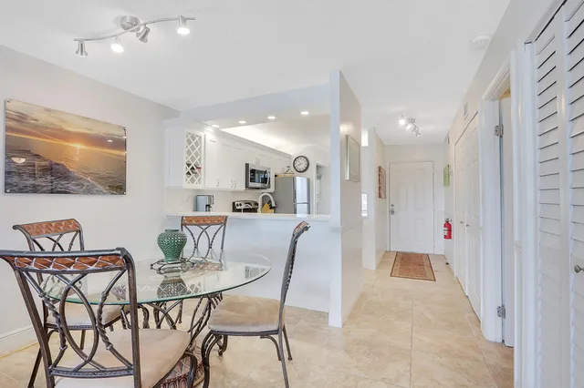 a dining room with furniture and a view of kitchen