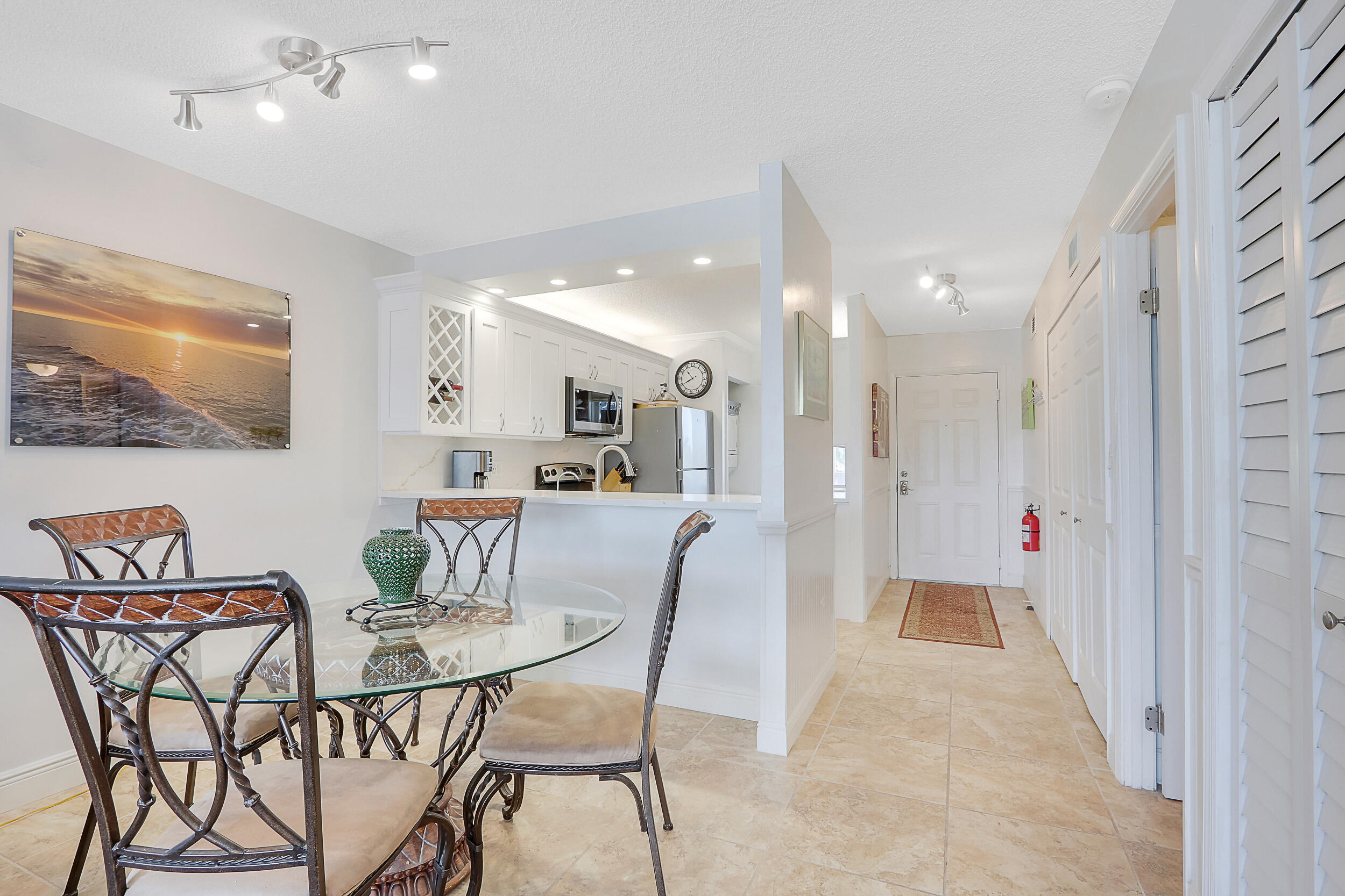 353 Highway 1, Unit A207 Jupiter, FL 33477 - Photo 4 of 28 a dining room with furniture and a view of kitchen