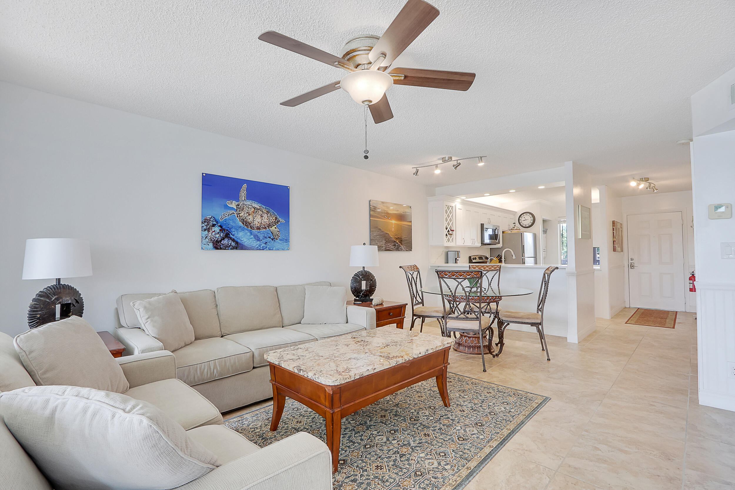 353 Highway 1, Unit A207 Jupiter, FL 33477 - Photo 8 of 28 a living room with furniture kitchen view and a chandelier