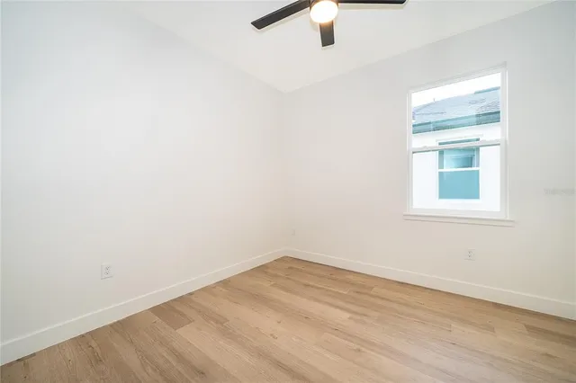 a bathroom with a granite countertop sink toilet and a mirror
