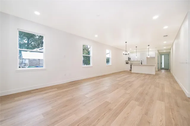 a view of a room with wooden floor cabinet and a window