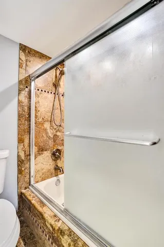 a bathroom with a shower and a toilet