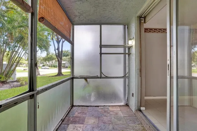 a view of a glass door with a hallway
