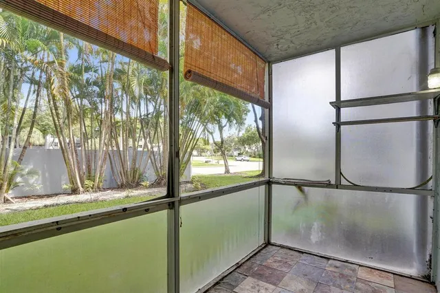 a view of a glass door with a yard from a window