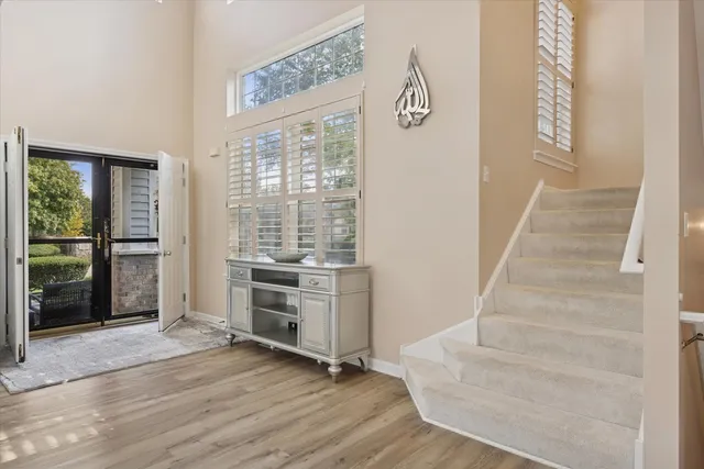 a view of an entryway with wooden floor and a living room