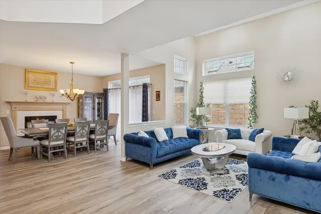 a living room with fireplace furniture and a wooden floor