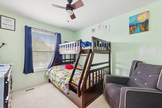 a bedroom with furniture and a wooden floor
