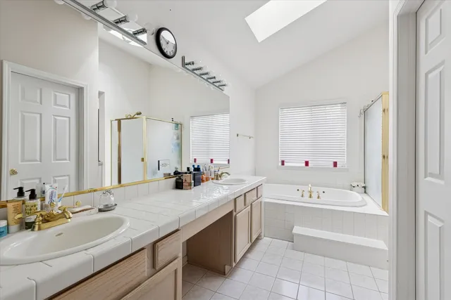 a bathroom with a tub sink and mirror
