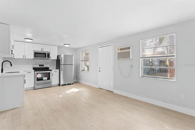 a view of a kitchen with a sink dishwasher and a refrigerator