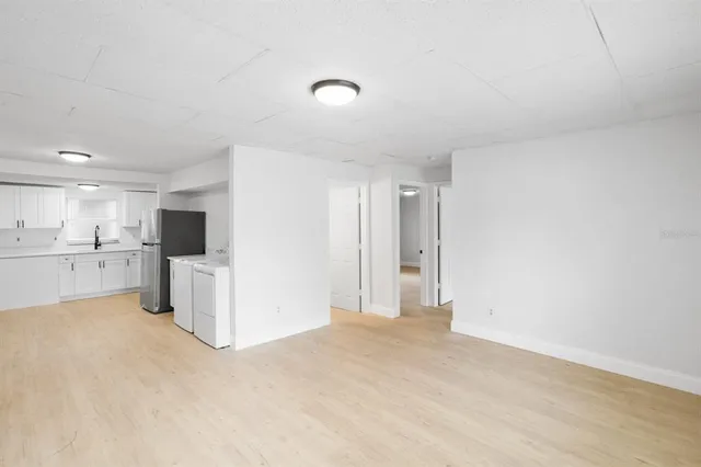 a view of a kitchen with a sink and a refrigerator