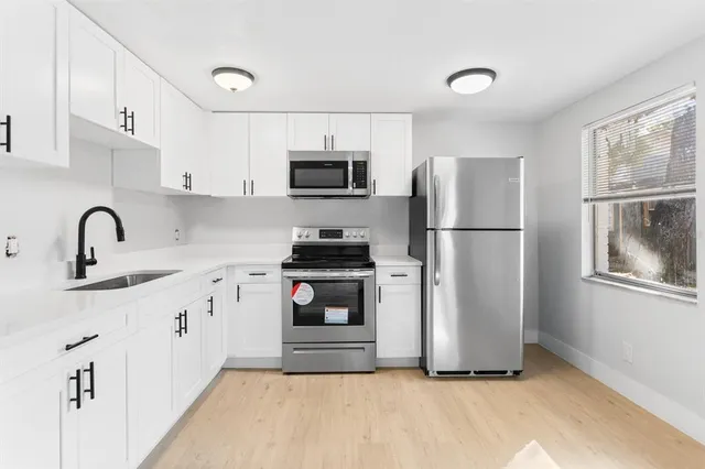a kitchen with a refrigerator sink and microwave