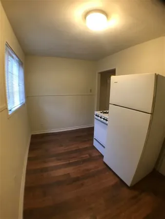 a view of a refrigerator with wooden floor