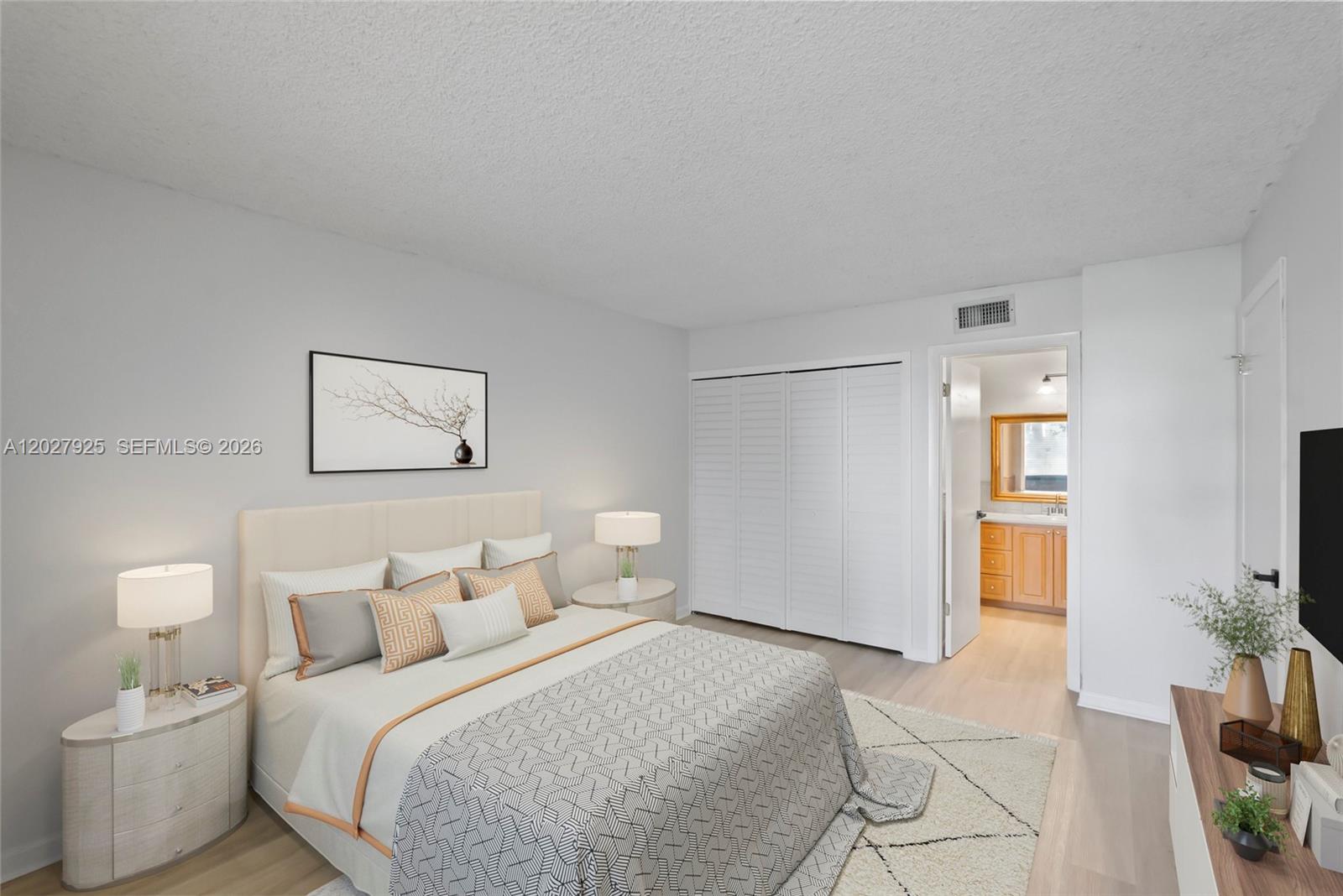 301 Racquet Club Road, Unit 103 Weston, FL 33326 - Photo 10 of 20 a bedroom with a bed and a lamp