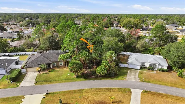 an aerial view of residential houses with outdoor space and swimming pool