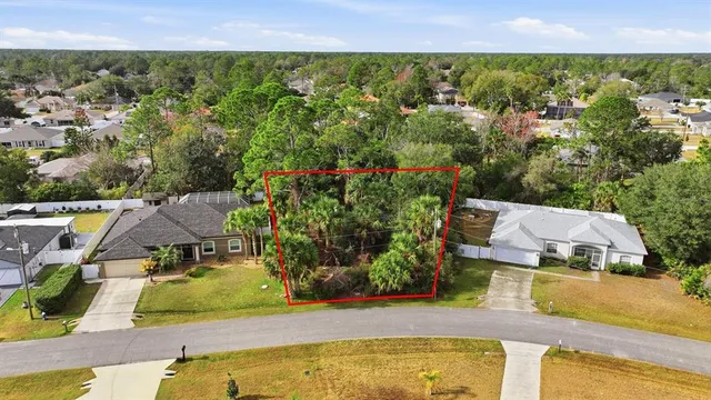 an aerial view of residential houses with outdoor space and swimming pool