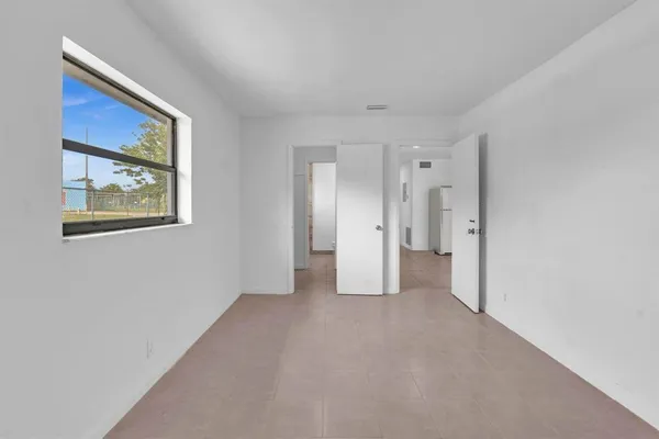 a view of an empty room with a cabinet