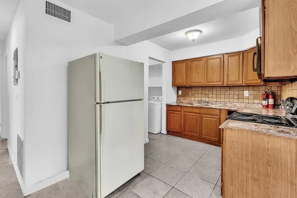 a kitchen with a refrigerator sink stove and cabinets