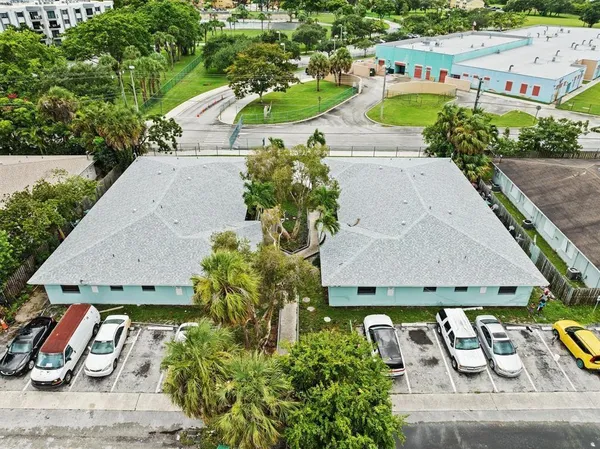 an aerial view of a house with garden space and street view