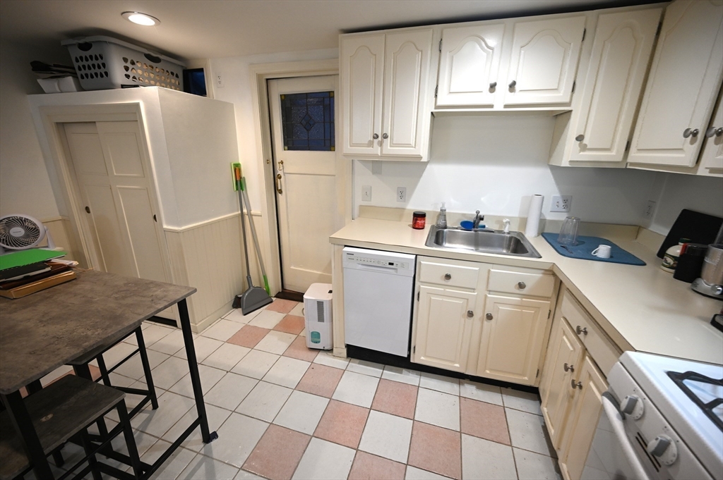 69 North Margin Street, Unit B Boston, MA 02113 - Photo 4 of 15 a kitchen with a sink a stove a refrigerator and cabinets