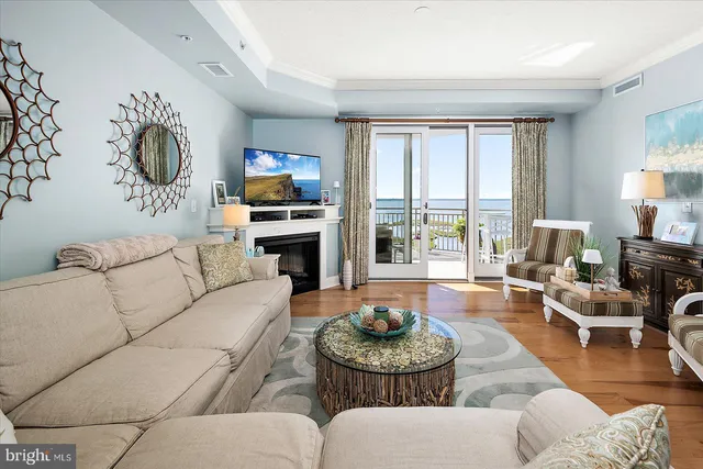 a kitchen with stainless steel appliances granite countertop a stove top oven a sink dishwasher a dining table and chairs with wooden floor