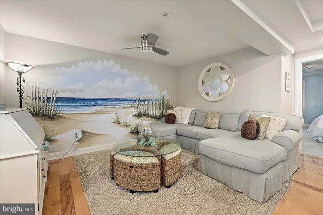 a living room with furniture a fireplace and a large window