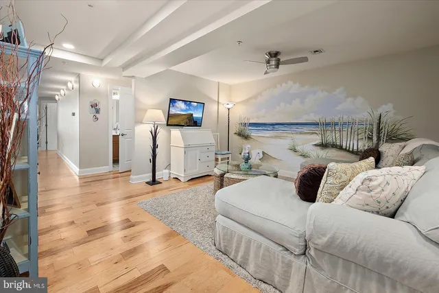 a living room with furniture fireplace and a large window