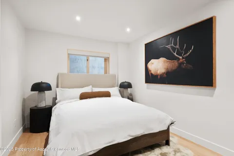 a bedroom with bed and wall painting