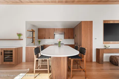 a view of a dining room with furniture and wooden floor