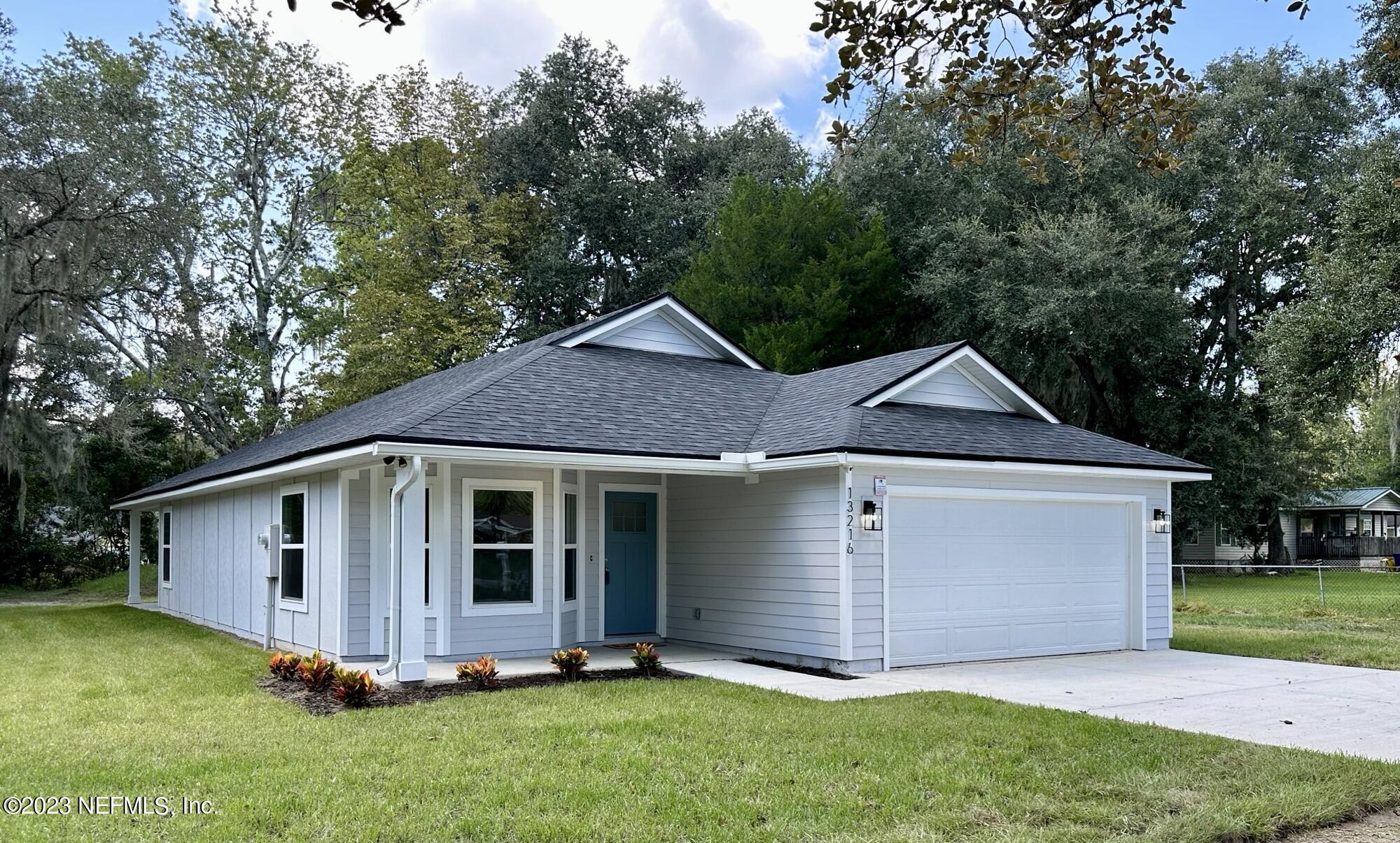 13216 Yellow Bluff Road Jacksonville, FL 32226 - Photo 1 of 28 a view of a house with a yard plants and large tree