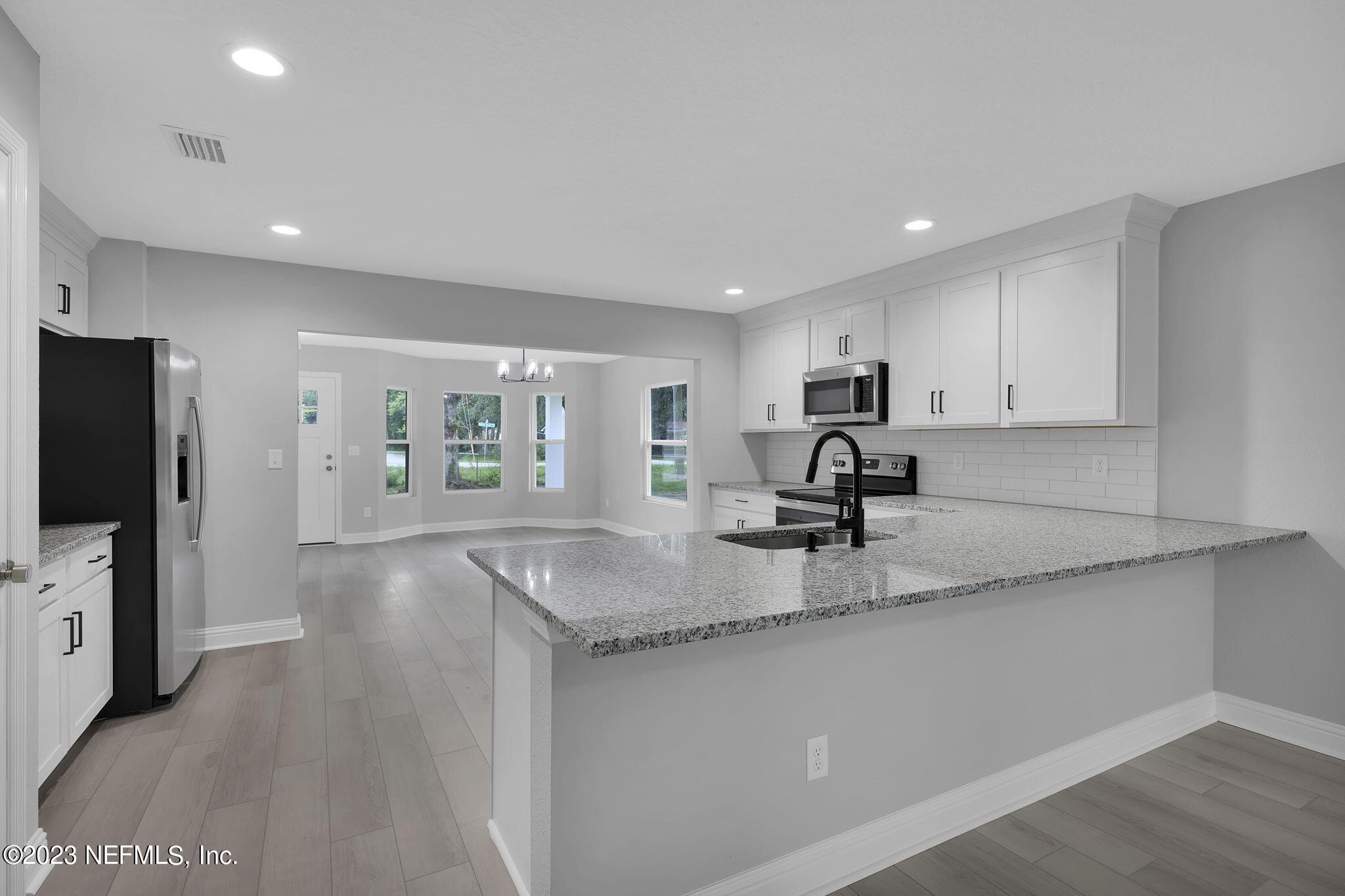 13216 Yellow Bluff Road Jacksonville, FL 32226 - Photo 11 of 28 a kitchen with stainless steel appliances granite countertop a sink a stove and a refrigerator