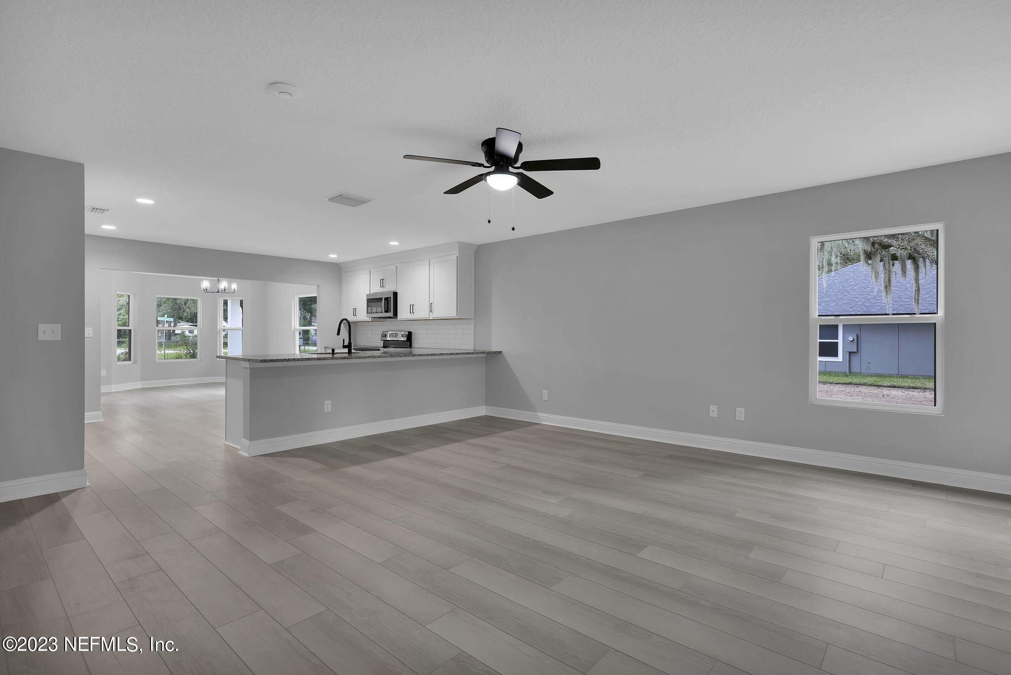 13216 Yellow Bluff Road Jacksonville, FL 32226 - Photo 12 of 28 a view of a kitchen with wooden floor and a kitchen space