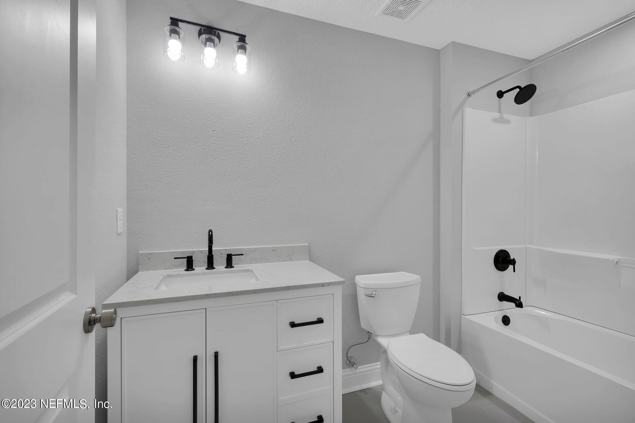 13216 Yellow Bluff Road Jacksonville, FL 32226 - Photo 17 of 28 a bathroom with a sink a toilet and shower