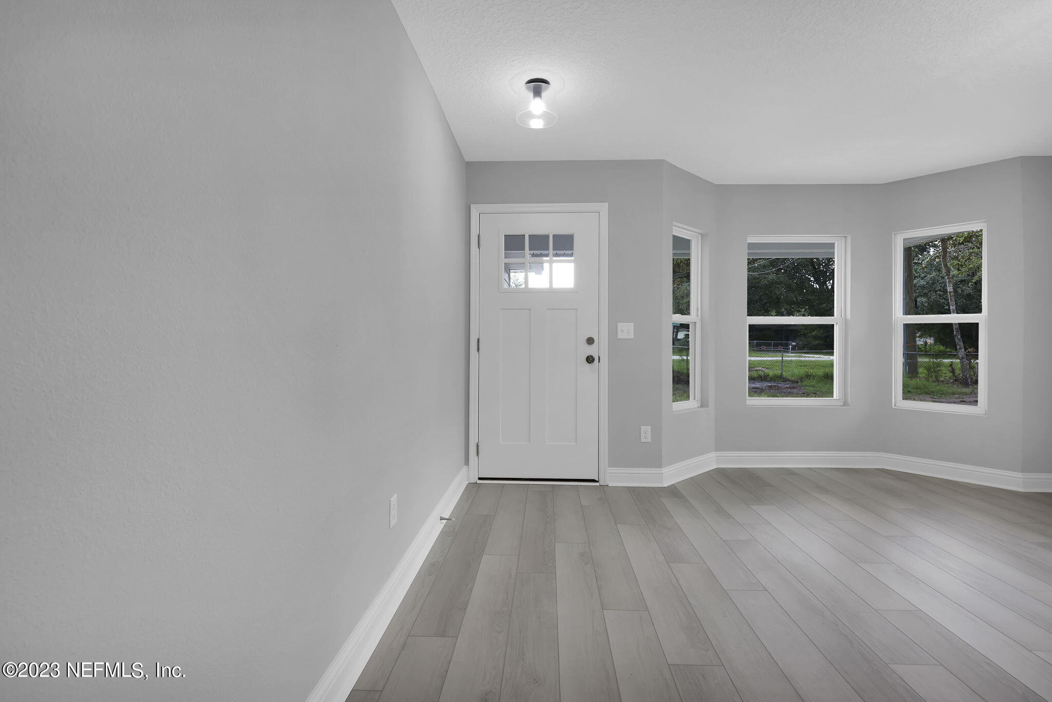 13216 Yellow Bluff Road Jacksonville, FL 32226 - Photo 2 of 28 wooden floor in an empty room with a window