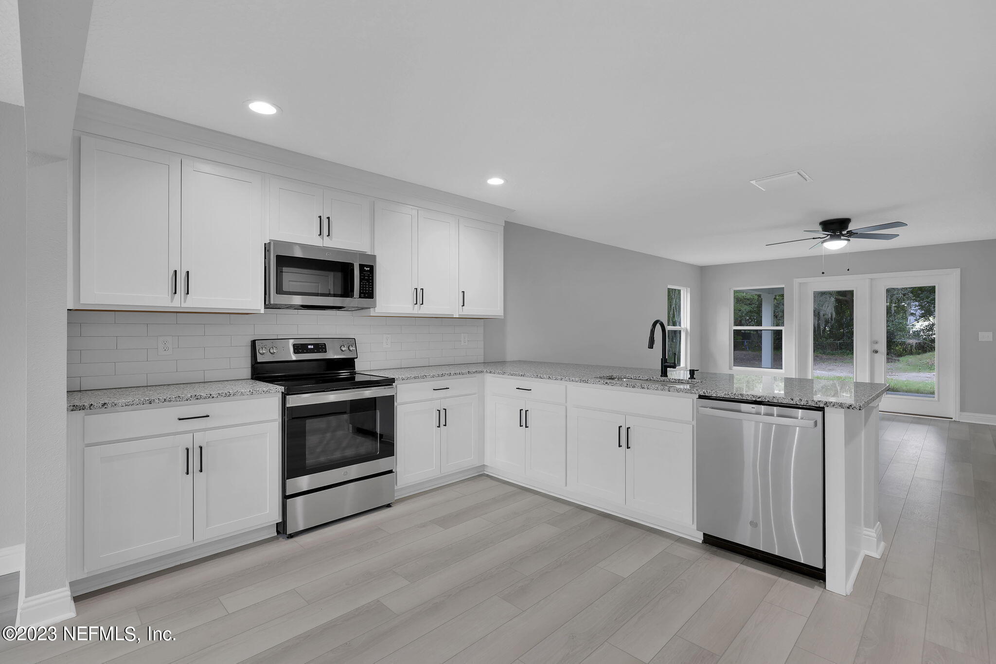 13216 Yellow Bluff Road Jacksonville, FL 32226 - Photo 7 of 28 a kitchen with granite countertop white cabinets and white appliances