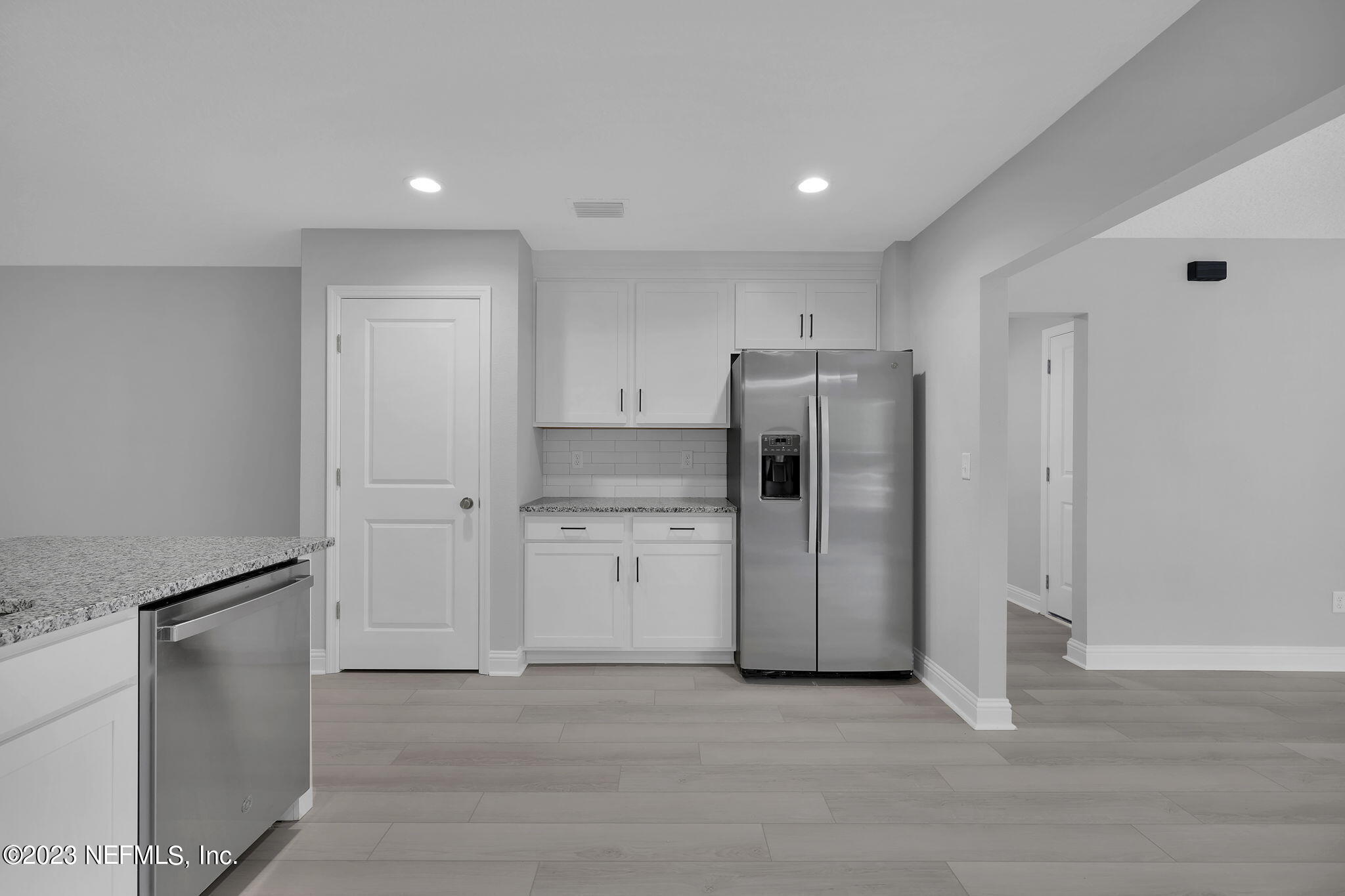 13216 Yellow Bluff Road Jacksonville, FL 32226 - Photo 9 of 28 a view of a kitchen with refrigerator and white cabinets
