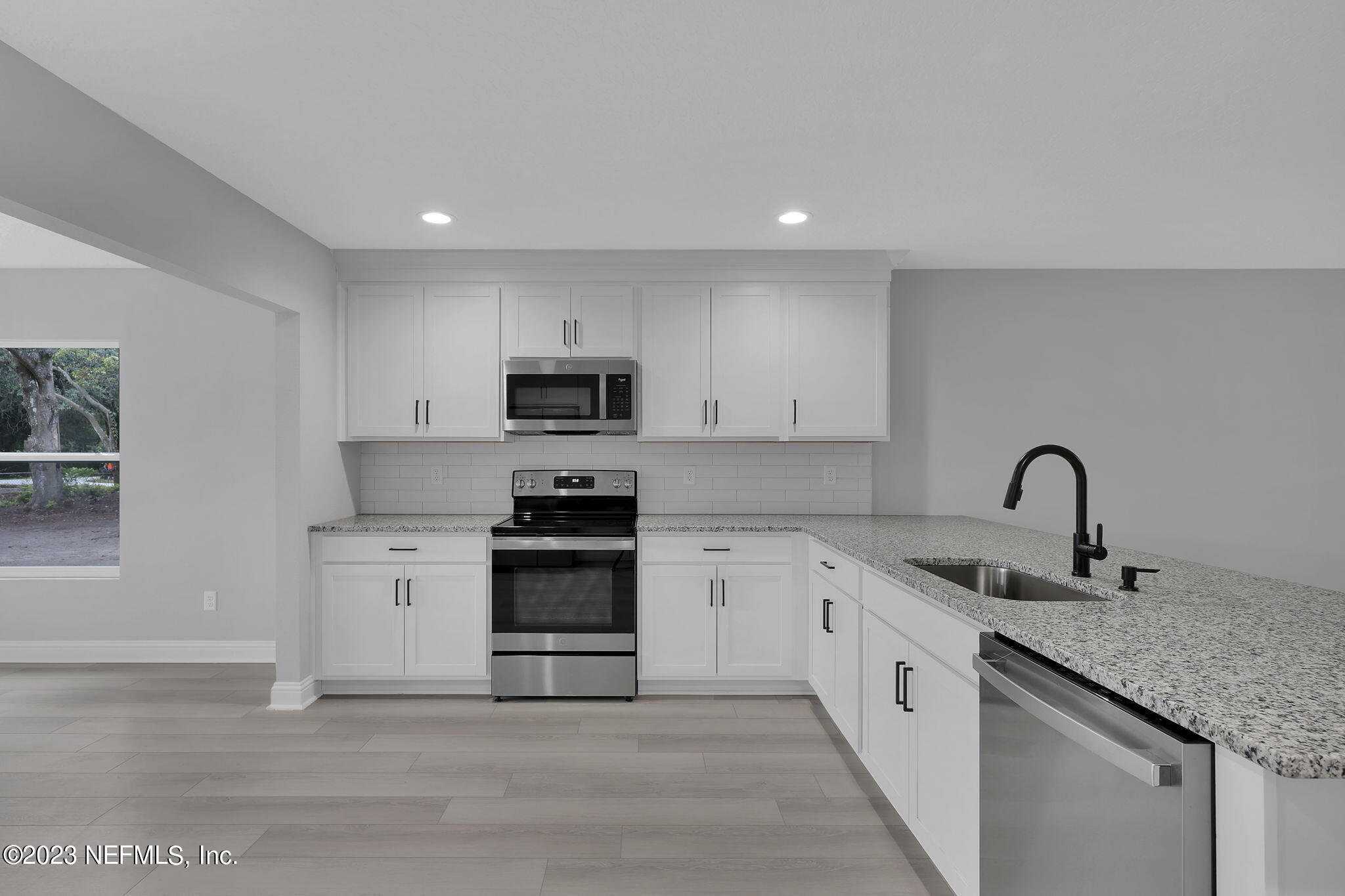 13216 Yellow Bluff Road Jacksonville, FL 32226 - Photo 10 of 28 a kitchen with white cabinets stainless steel appliances and sink
