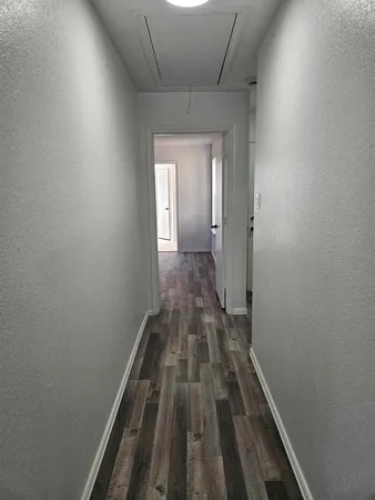 a view of a hallway with wooden floor