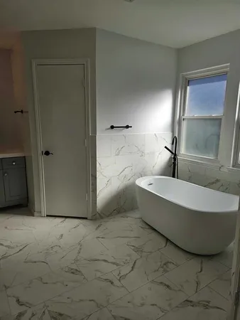a bathroom with a tub and shower