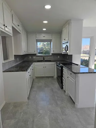 a kitchen with a sink and cabinets