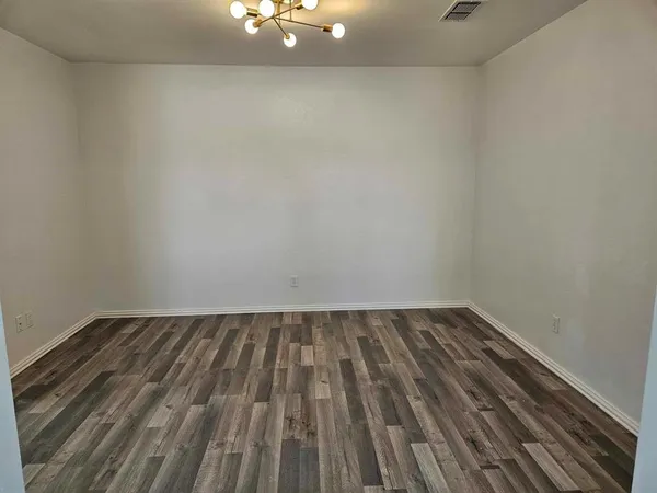 a view of an empty room and wooden floor