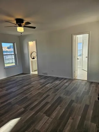 a view of an empty room with a window