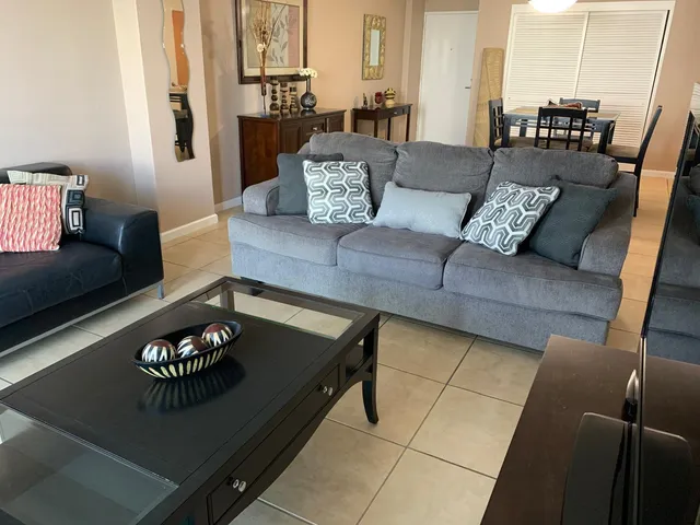 a living room with furniture rug and window
