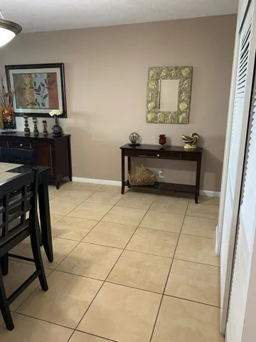 a living room with furniture and a painting on the wall
