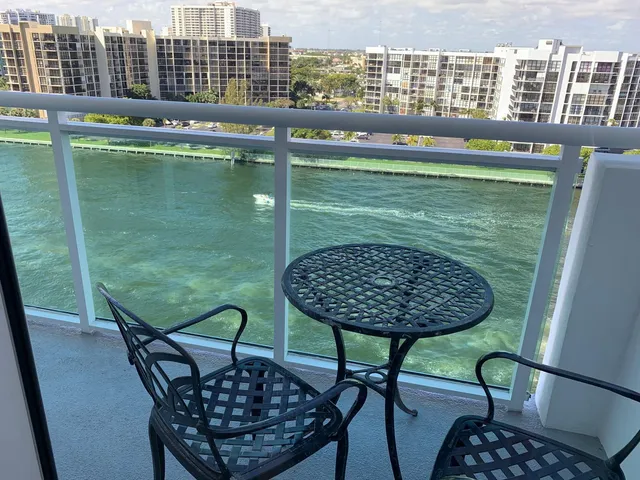 a view of balcony with table and chairs