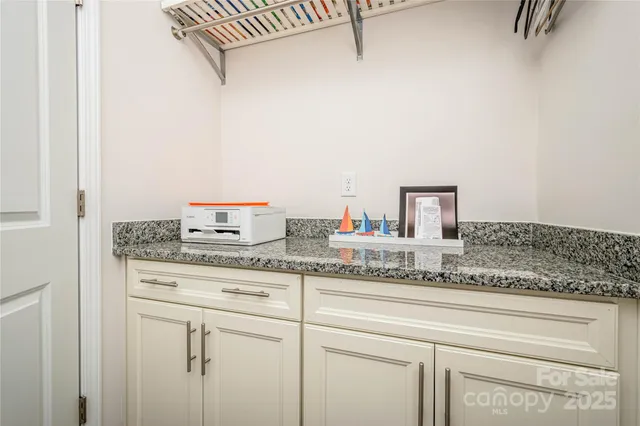 a bathroom with a granite countertop sink and vanity
