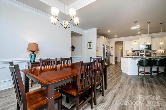 a dining room with furniture and wooden floor