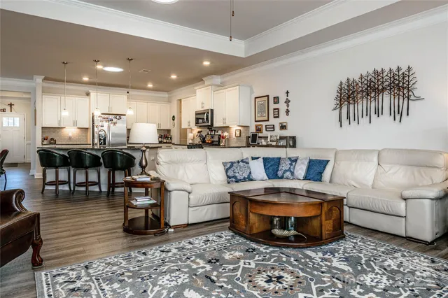 a living room with furniture and view of kitchen