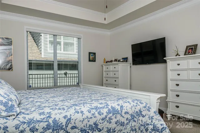 a bedroom with a bed and a flat screen television